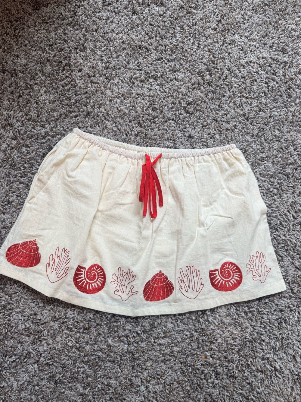 Cream Beach Embroidered Mini Skirt with Red Shell Accents